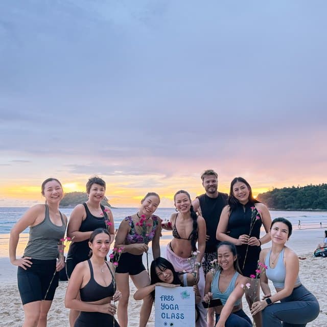 Sunset beach yoga class group photo