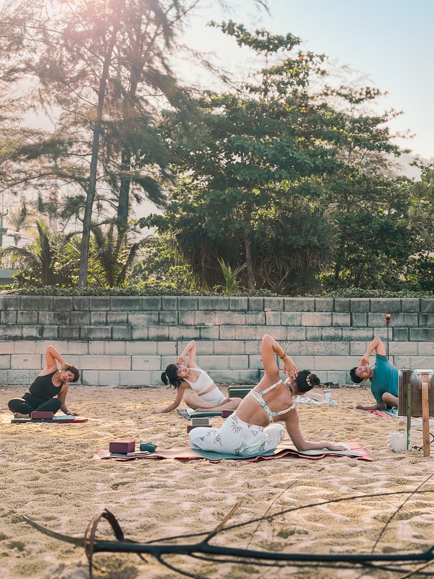 Beach yoga group practice at sunrise