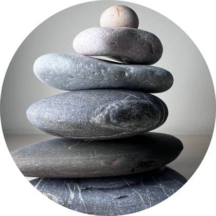 A balanced stack of smooth grey stones