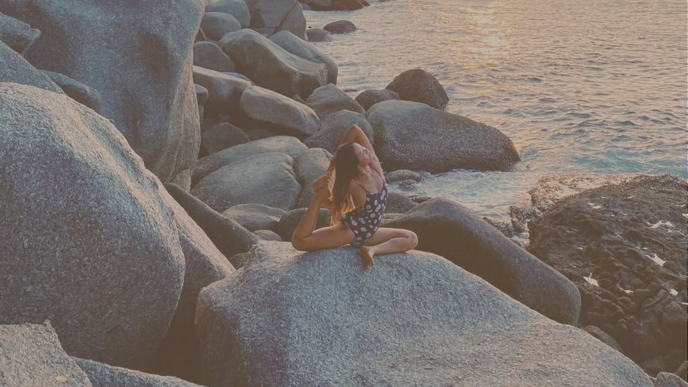 A seated practice among the granite boulders at the water's edge